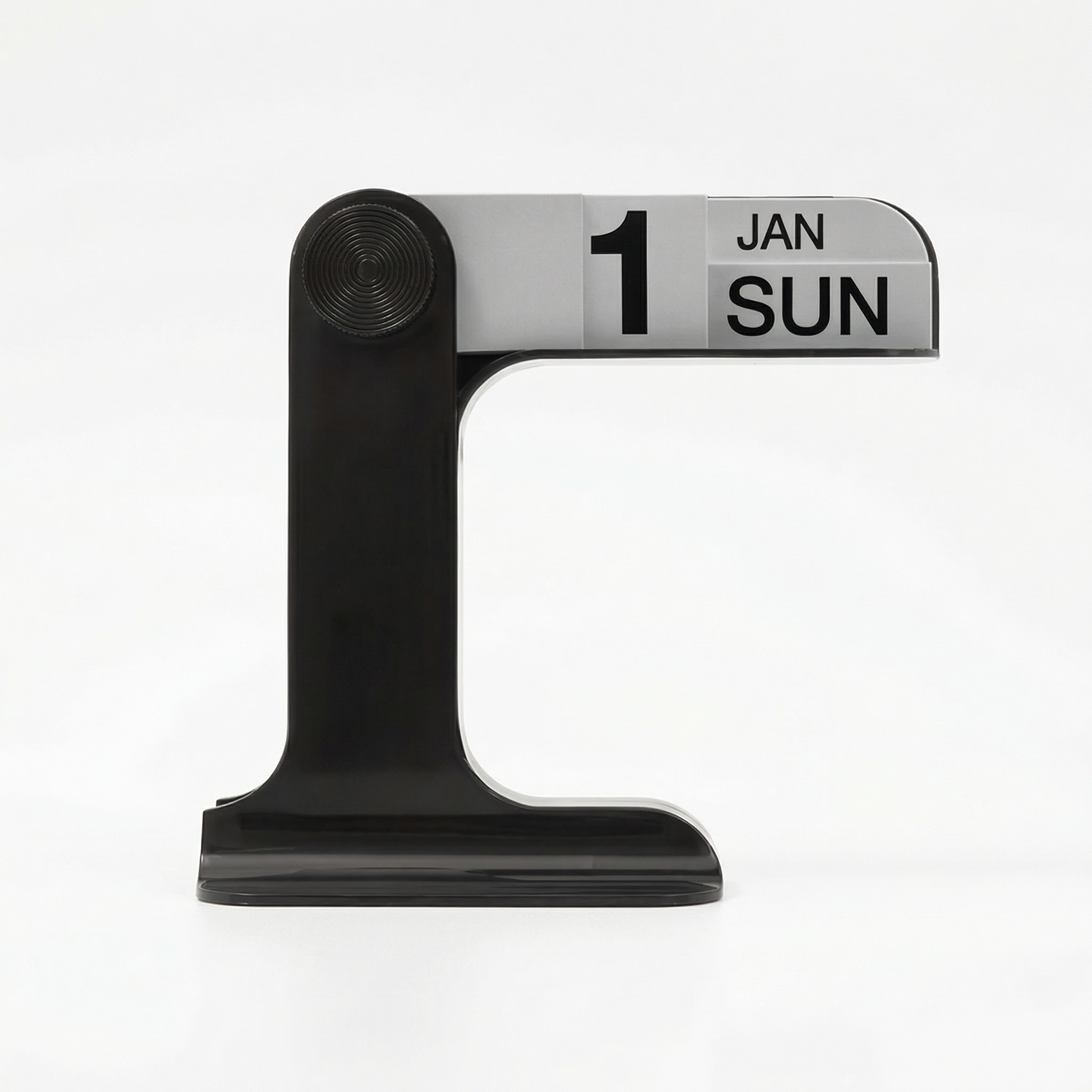 Retro manual flip calendars in mustard yellow, forest green, and black on a white desk