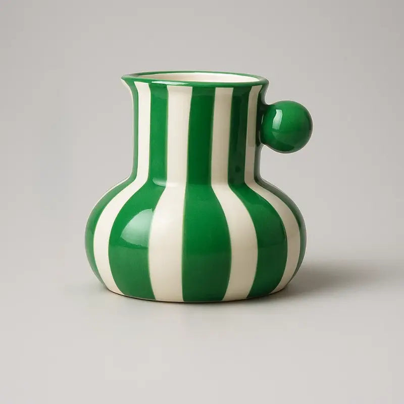 Collection of striped ceramic pitcher vases in green red blue black and yellow with flowers