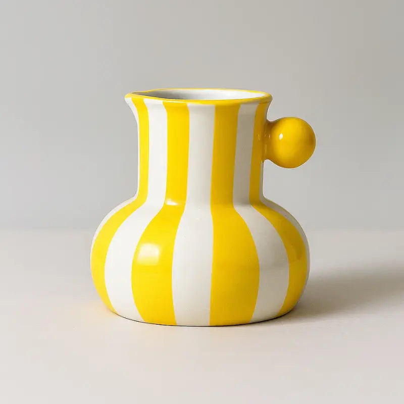 Collection of striped ceramic pitcher vases in green red blue black and yellow with flowers