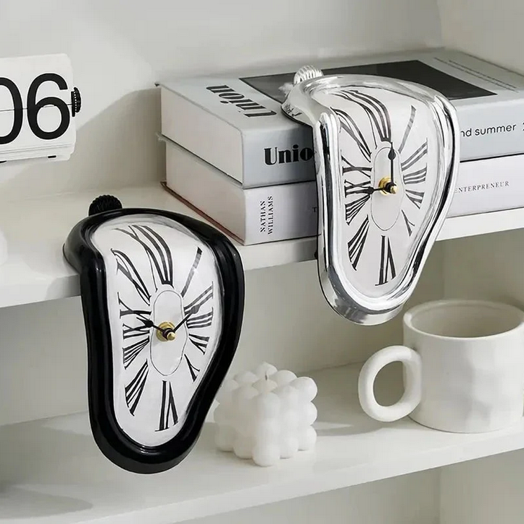 Silver surrealist melting clock resting on the edge of a metal bookshelf next to books