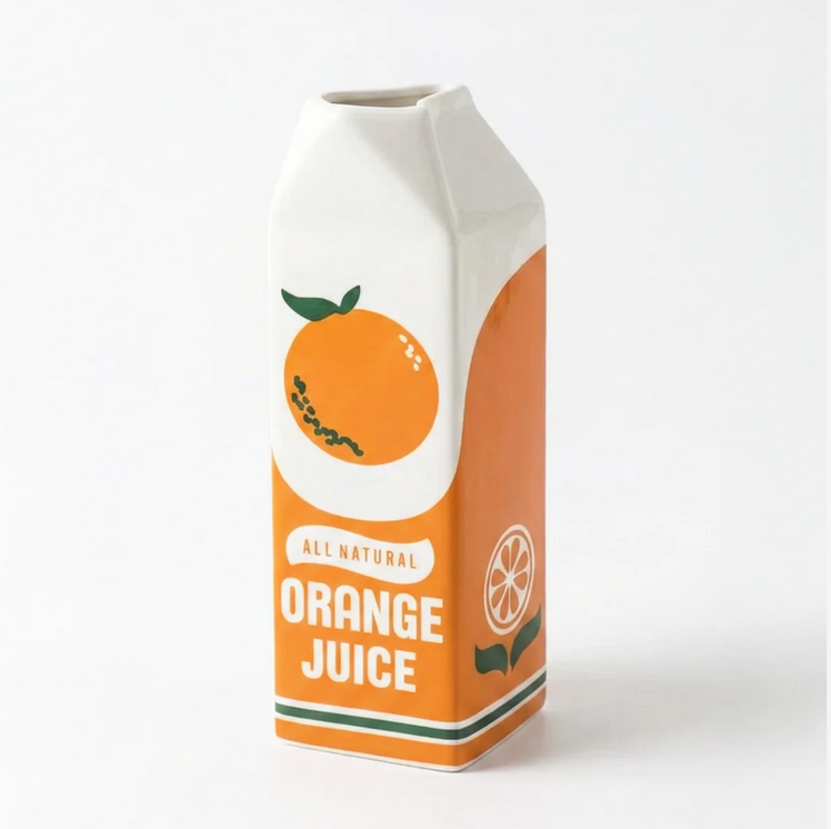 Ceramic vase shaped like an orange juice carton