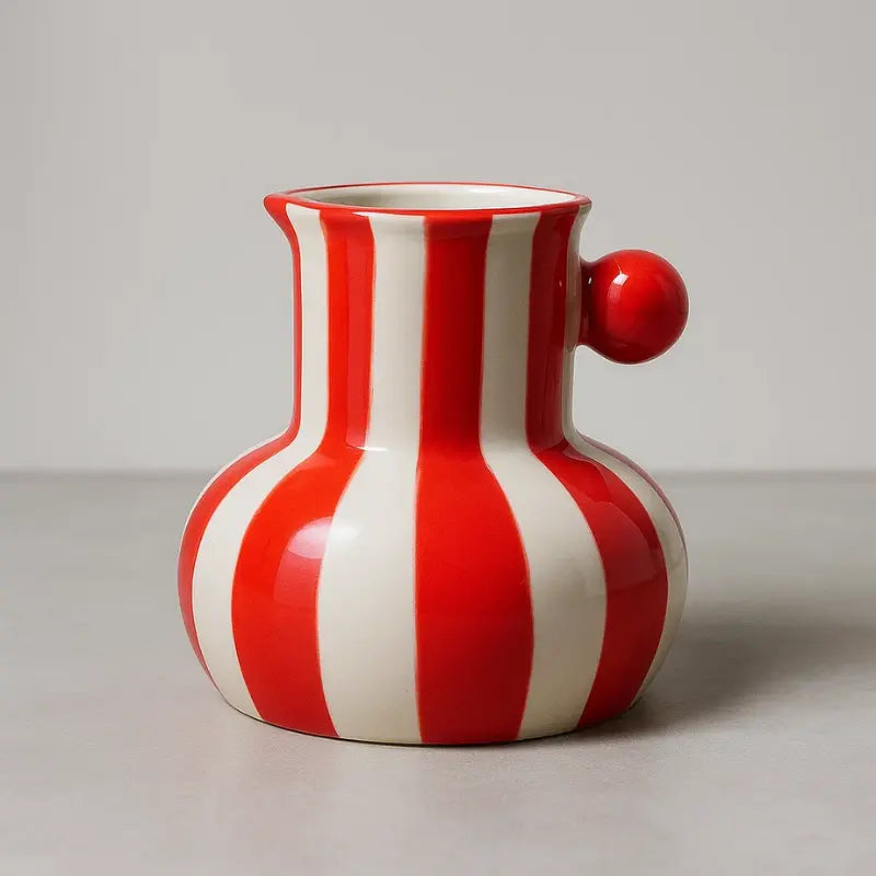 Collection of striped ceramic pitcher vases in green red blue black and yellow with flowers